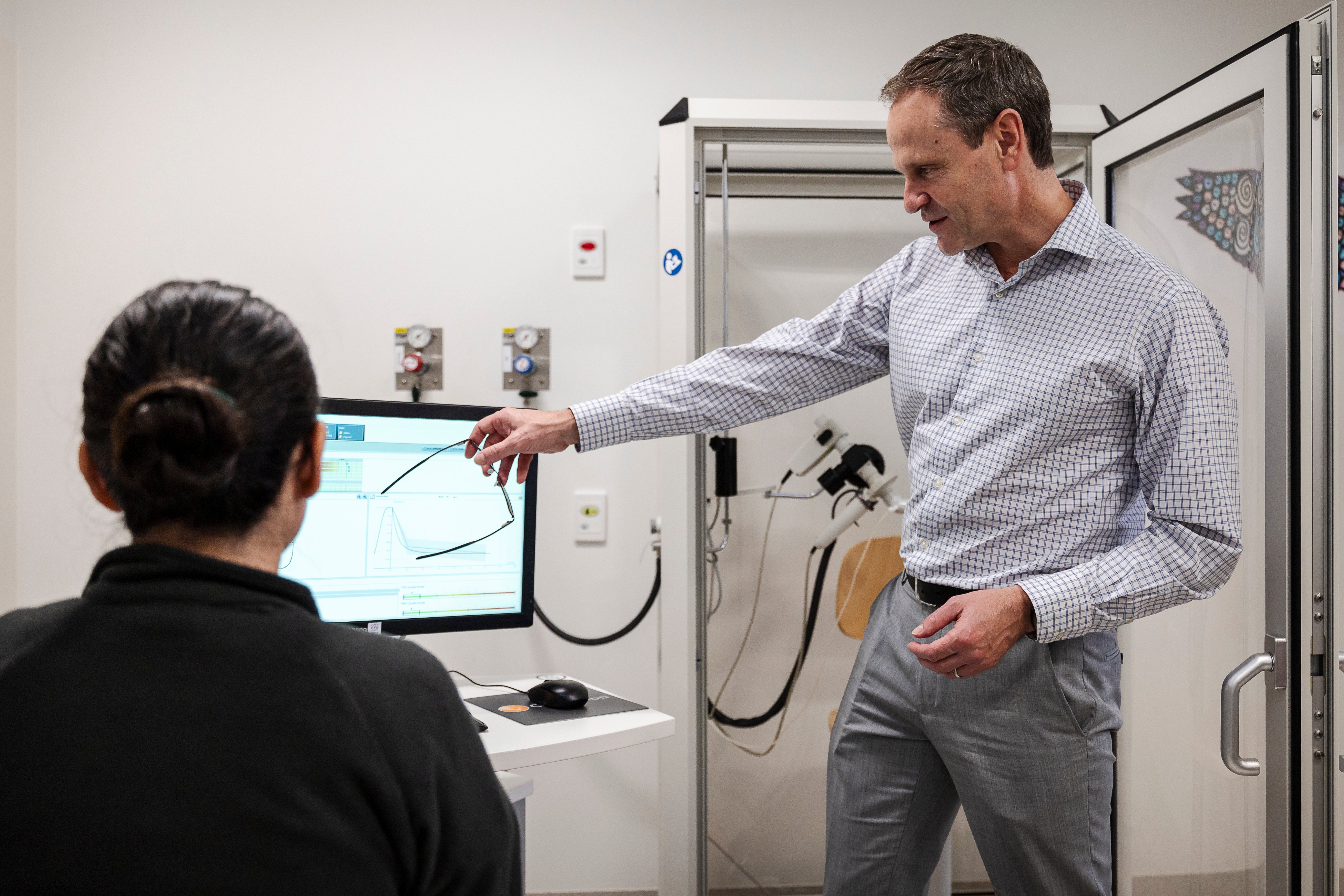 Clinician consulting with a patient - pointing at a screen