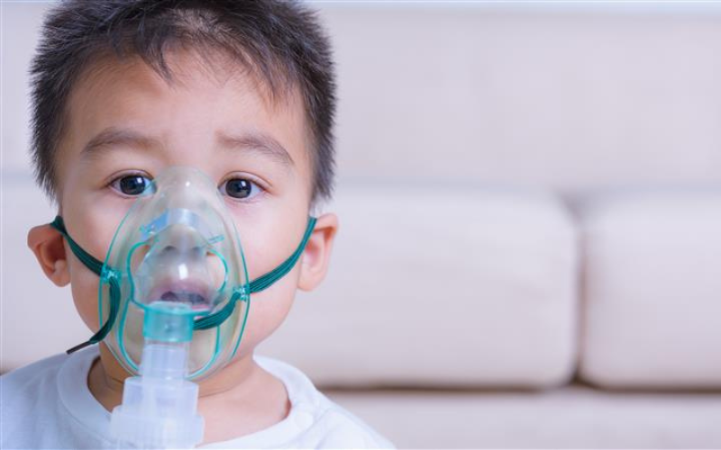 Little boy from Asian descent with oxygen mask