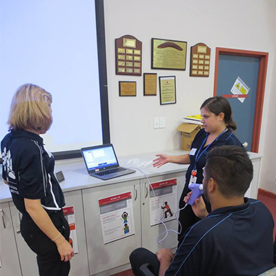 three people standing next to an easy on pc